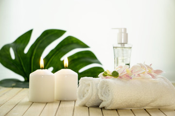 Spa setting still life with orchid flower , candle, soap and towels on white background