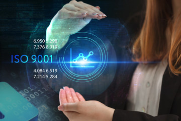 The concept of business, technology, the Internet and the network. A young entrepreneur working on a virtual screen of the future and sees the inscription: ISO 9001