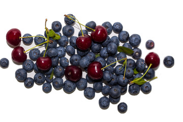 Fresh cherries and blueberries on white isolated background