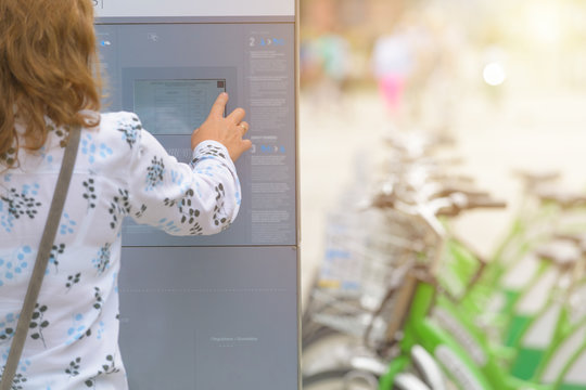 Renting bicycle from urban bicycle sharing station