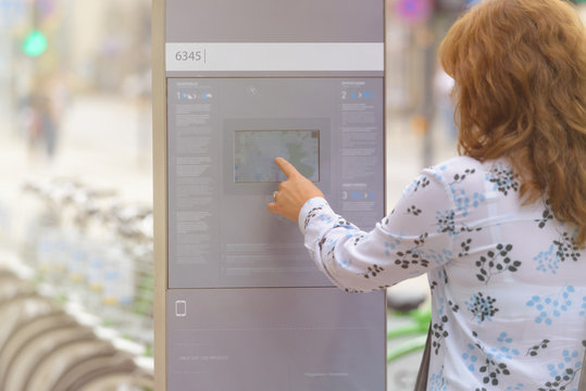 Renting bicycle from urban bicycle sharing station