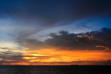 The ship was carrying cargo at sea on a patterned background evening sky. 2