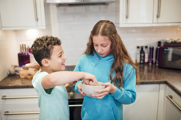 Siblings Sharing Fruit at Home