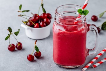 Cherries and banana smoothie in glass mason jar