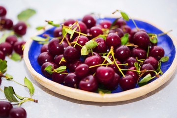 Fresh cherries in bowl on table
