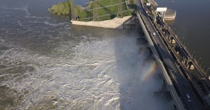 Aerial view to the Novosibirsk hydroelectric power station with waterfall on a sunny summer windless day with rainbow