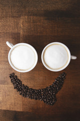 Morning coffee smile cups on wooden background