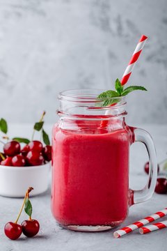 Cherries and banana smoothie in glass mason jar