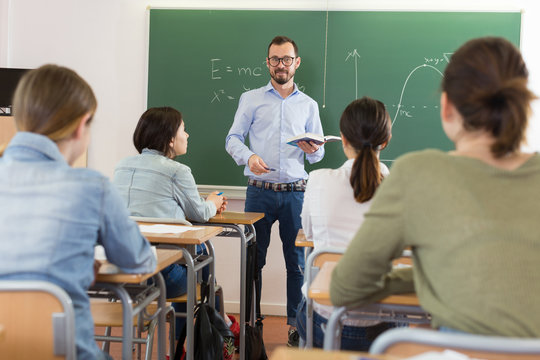 Man teacher is giving interesting lecture for students