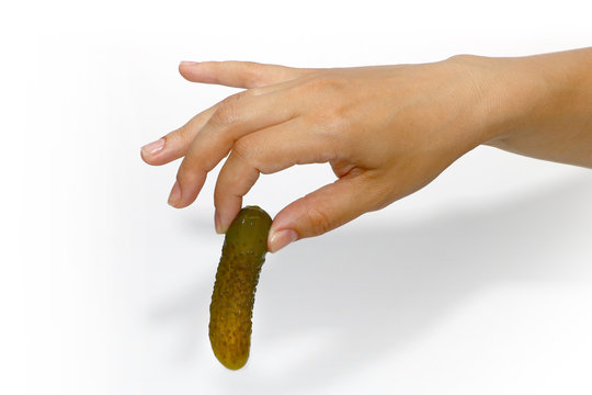 pickled cucumber in a hand on a white background