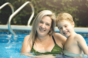 Mother and baby swim in the pool