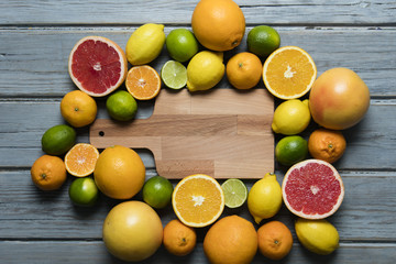 Citrus fuits, grapefruit, lemon, lime, orange on a rustic wooden background