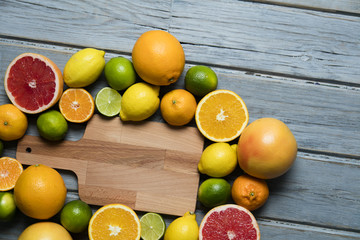 Citrus fuits, grapefruit, lemon, lime, orange on a rustic wooden background