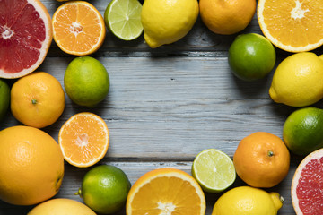 Fototapeta na wymiar Citrus fuits, grapefruit, lemon, lime, orange on a rustic wooden background