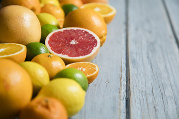 Citrus fuits, grapefruit, lemon, lime, orange on a rustic wooden background