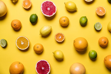Citrus fuits, grapefruit, lemon, lime, orange on a yellow background