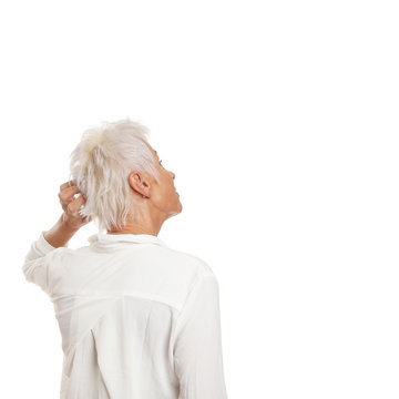 Puzzled Older Woman Scratching Her Head And Looking Up To Copy Space