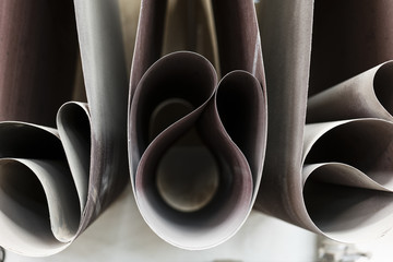 Closeup of sanding belts ready to be used in a wood working shop.