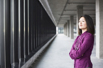 An Asian female business owner in a new raw business space.