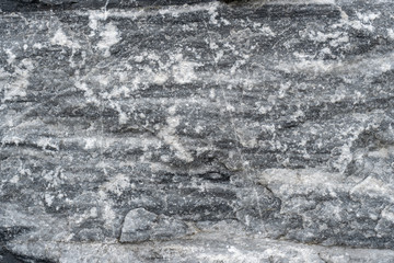 Gray surface of marble stone with striped streaks.