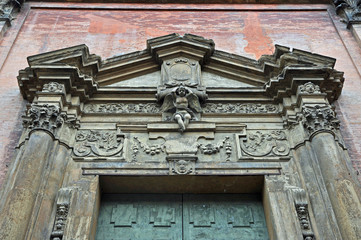 Obraz premium Italy, Bologna Santissimo Salvatore Baroque style church front door top decorations.