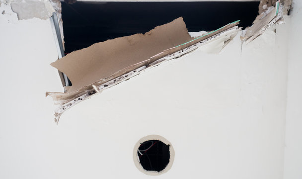 Ceiling panels damaged huge hole in roof from rainwater leakage.Water damaged ceiling .