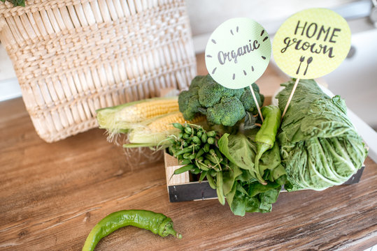 Green healthy food brought from the eco market or own garden on the kitchen table