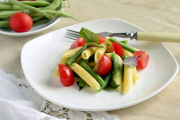 Penne pasta with green beans, cherry tomatoes and basil