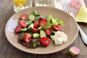 Strawberry salad with cucumber and  lettuce with yogurt sauce