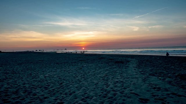 sunrise over the ocean from beach in Ocean City, New Jersery with Atlantic City in background time lapse video