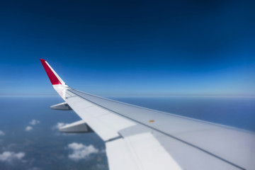 selective focus  Airplan wing above the blue sky