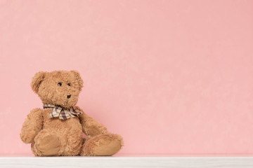 Soft teddy bear. Toy on a pink background.