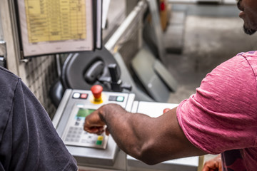 African man showing how to use the automated warehosue