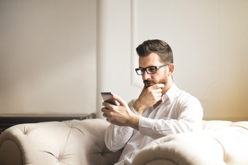 Man with a smartphone in the living room