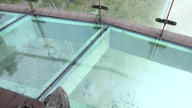 Tourists at the section with glass floor of the Tianmen mountain top path. China