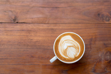 Hot coffee cup on wooden table