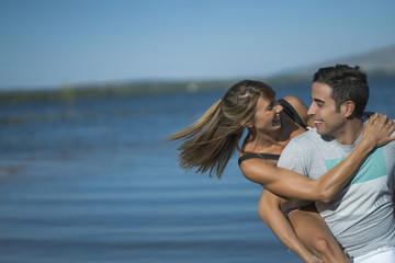 Romantic couple playing outdoors by the lake