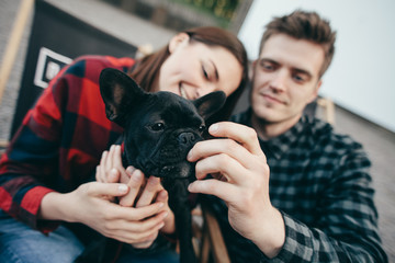Loving couple with pet french bulldog