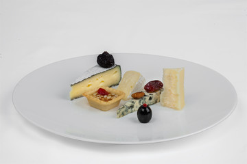 Cheese plate with nuts, dates, almonds and olives.