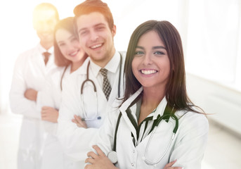 Fototapeta premium female doctor with group of happy successful colleagues