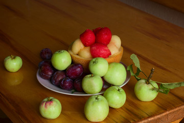 fresh sweet fruits on a plate on a wooden table