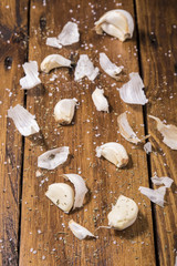 Pieces of garlic cloves spread on a wooden board