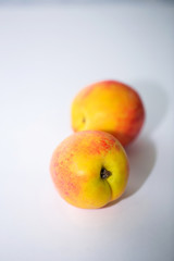 Two ripe nectarines on a white background. Food photo, fruit