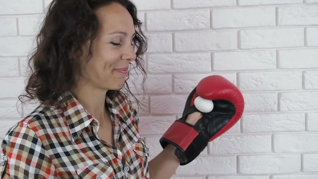 Emancipation. Woman in boxing gloves with egg.