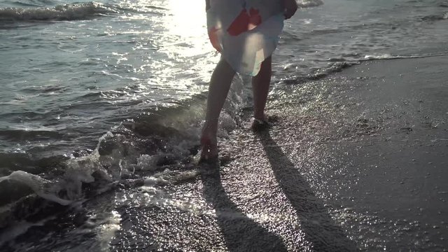 Beautiful woman legs, walking on the beach