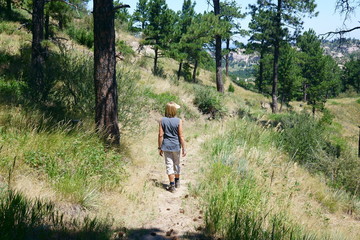 Naklejka na ściany i meble Woman hiking on a trail in the wildcat hills