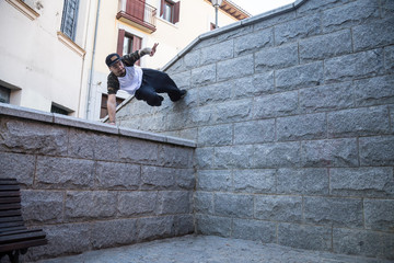 Young man doing an amazing parkour trick on the street. 