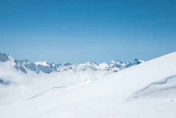 Winter snow covered mountain peaks in Caucasus. Great place for winter sports