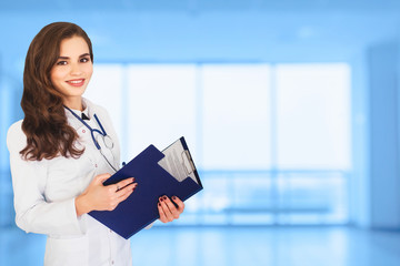 Medicine Thesis. Healthcare. portrait of a performing Surgery Female Doctor in front of a bright Blue Background wide promotional banner