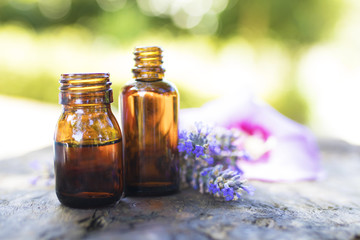 oil jars or lavender essence with a bouquet of natural lavender flowers